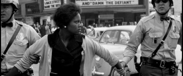 USA. Alabama. Birmingham. 1963. A female protester being arrested and led away by the police.