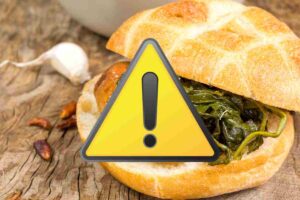 panino salsiccia e broccoli e un segnale generico di pericolo