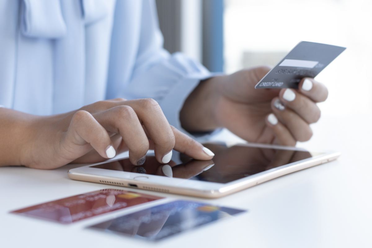 persona usa tablet e carte bancomat